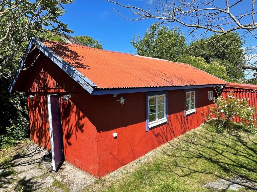 a red barn with a red roof at Holiday home Skärhamn VII in Skärhamn