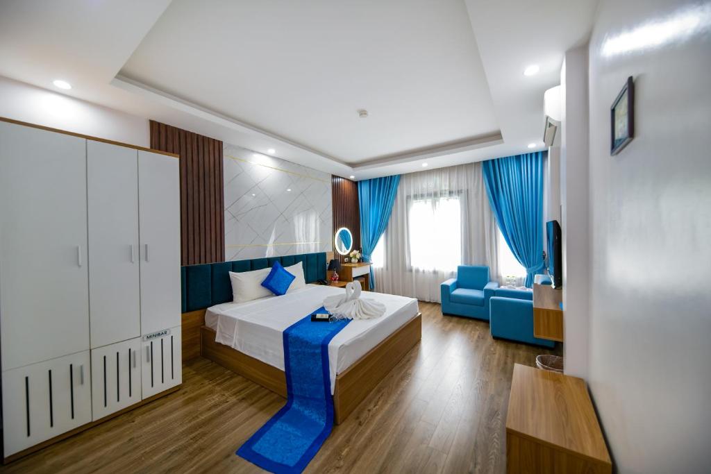 a hotel room with a bed and a couch at Aquarius Grand Hotel in Hanoi