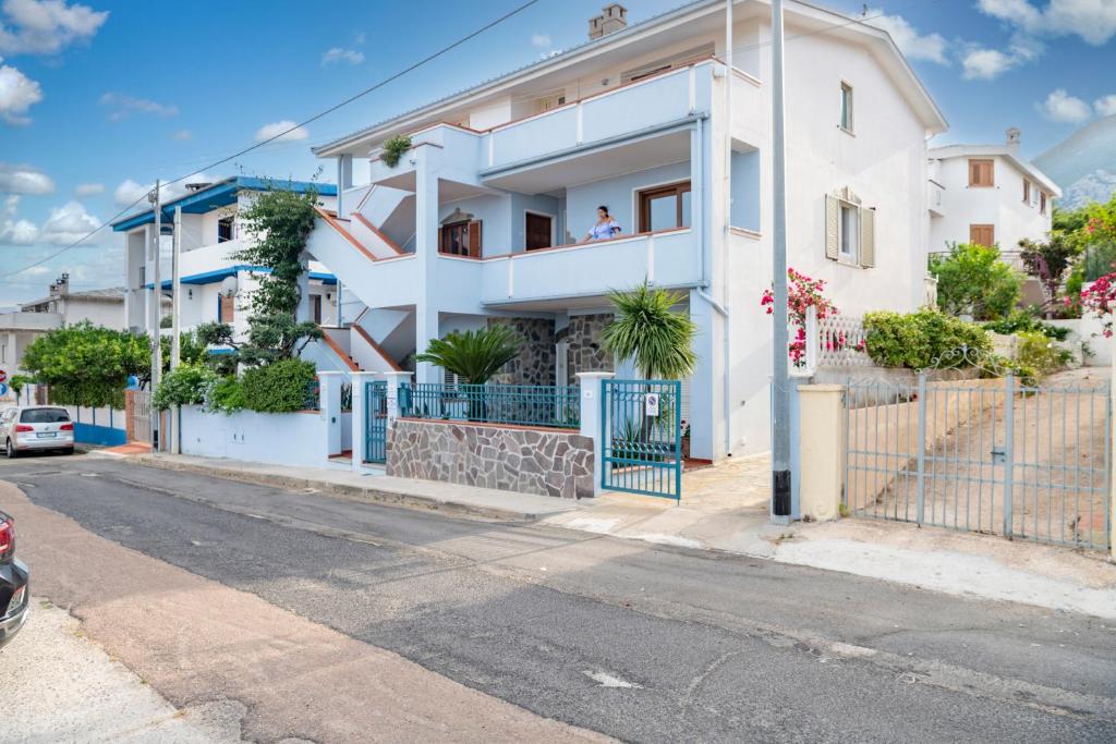 a white house on the side of a street at Biriola EcoResort Cala Gonone in Cala Gonone