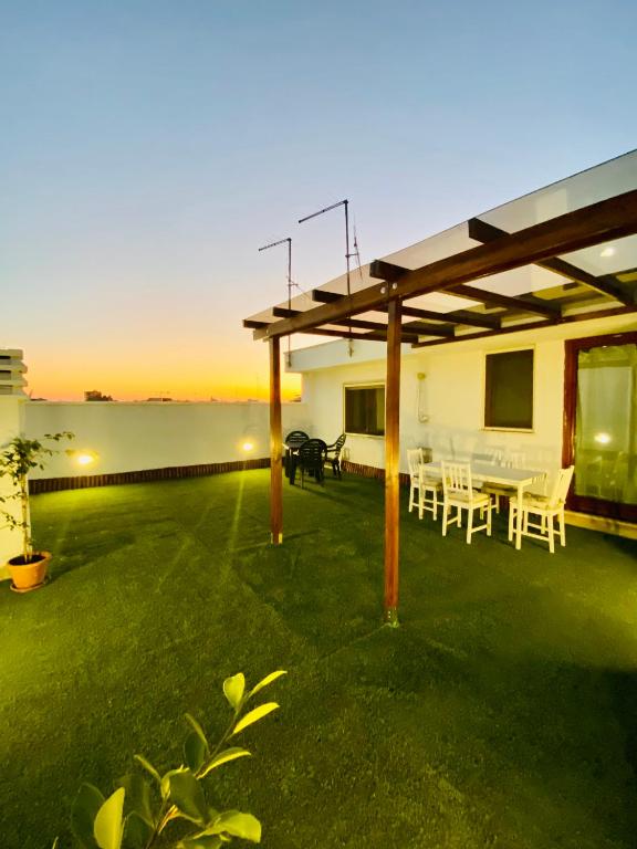 a patio with a table and chairs and the ocean at Lucky’s house in Noicattaro