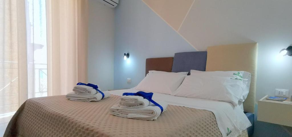 a bedroom with a bed with towels on it at Casa Vacanze Vicolo San Pietro in Agrigento
