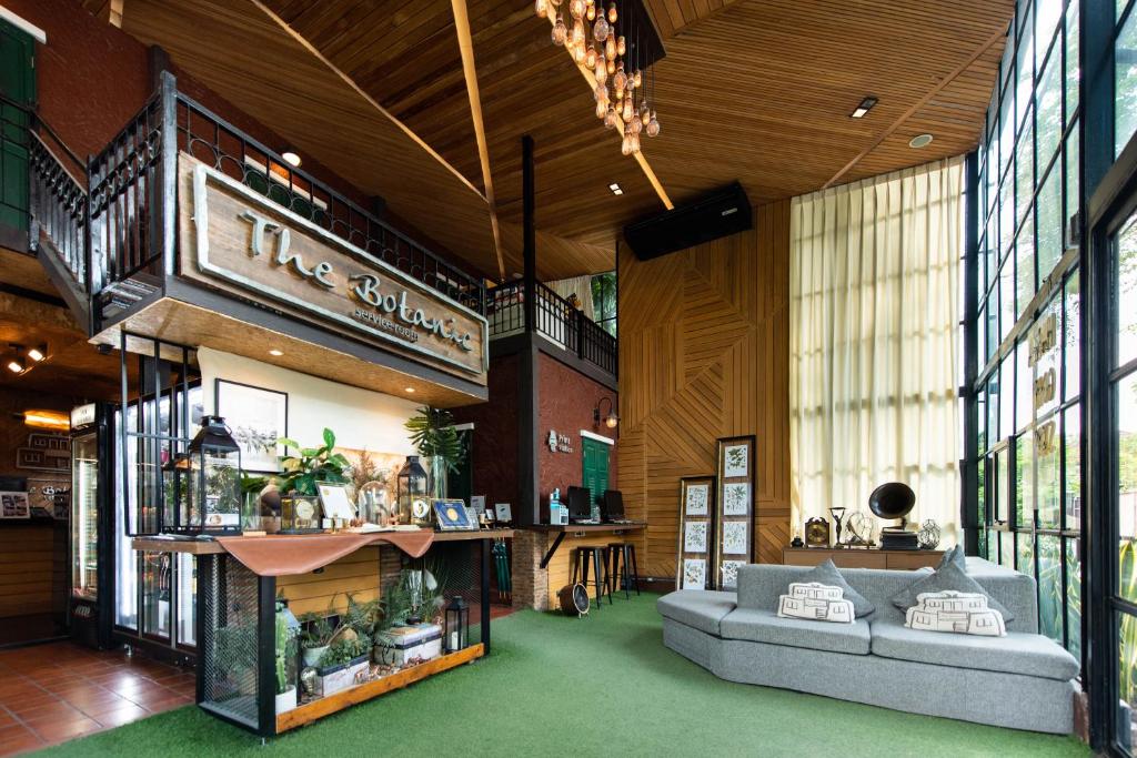 a store with two couches in a room with windows at Botanic Service Room at Impact Muangthongthani - SHA Certified in Nonthaburi