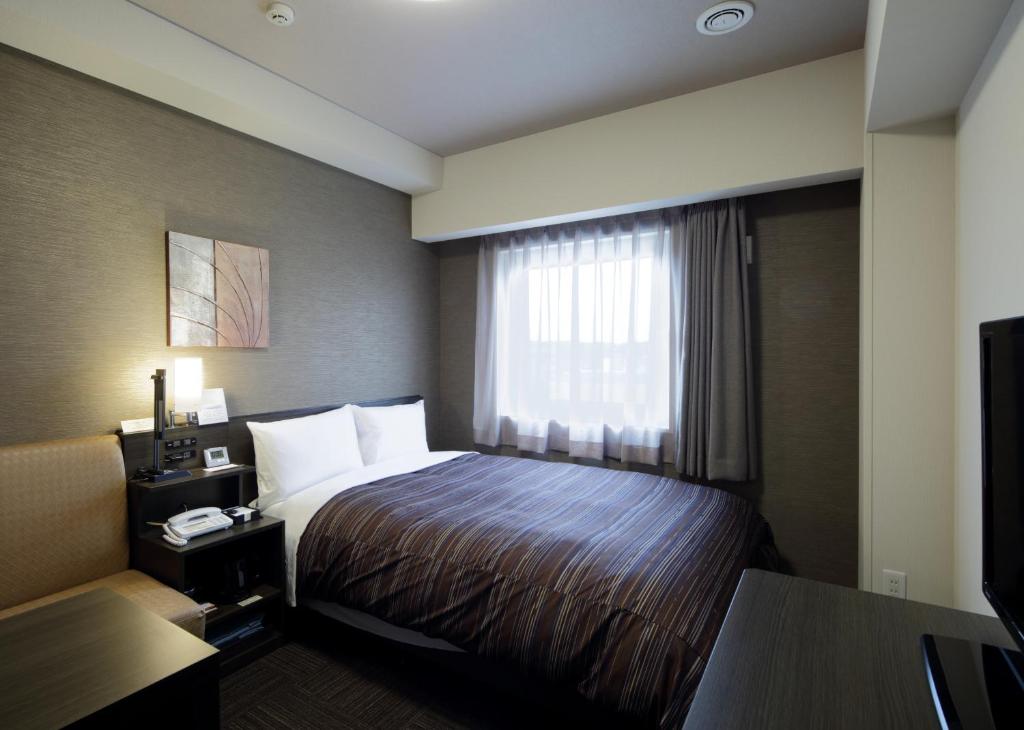 En eller flere senge i et værelse på Hotel Route-Inn Seki