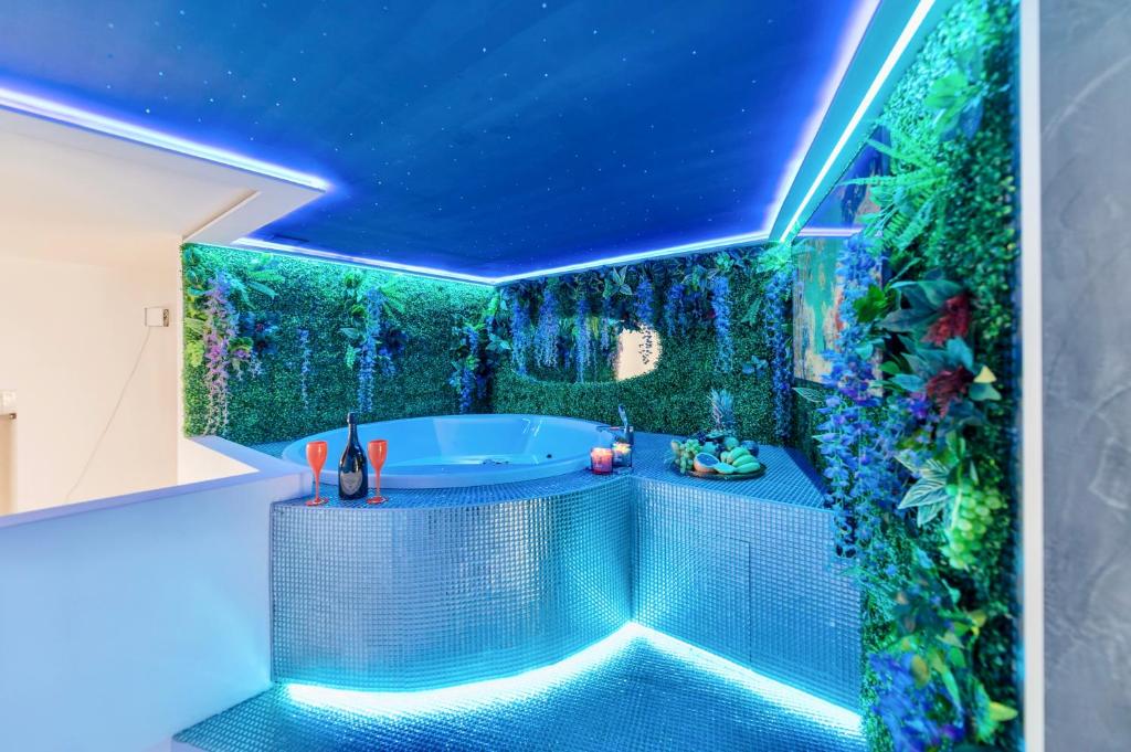 a bathroom with a green wall with a bath tub at Jacuzzi Basilica view in Budapest