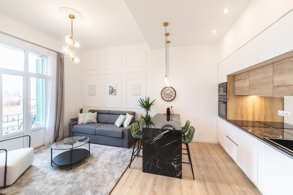 a living room with a couch and a table at MONTE CARLO BORDER - exclusive & modern flat in Beausoleil