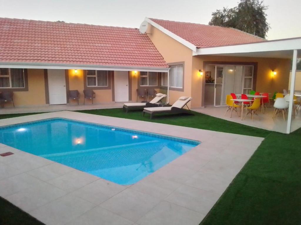 a house with a swimming pool in the yard at Benoni N12 Hotel in Benoni