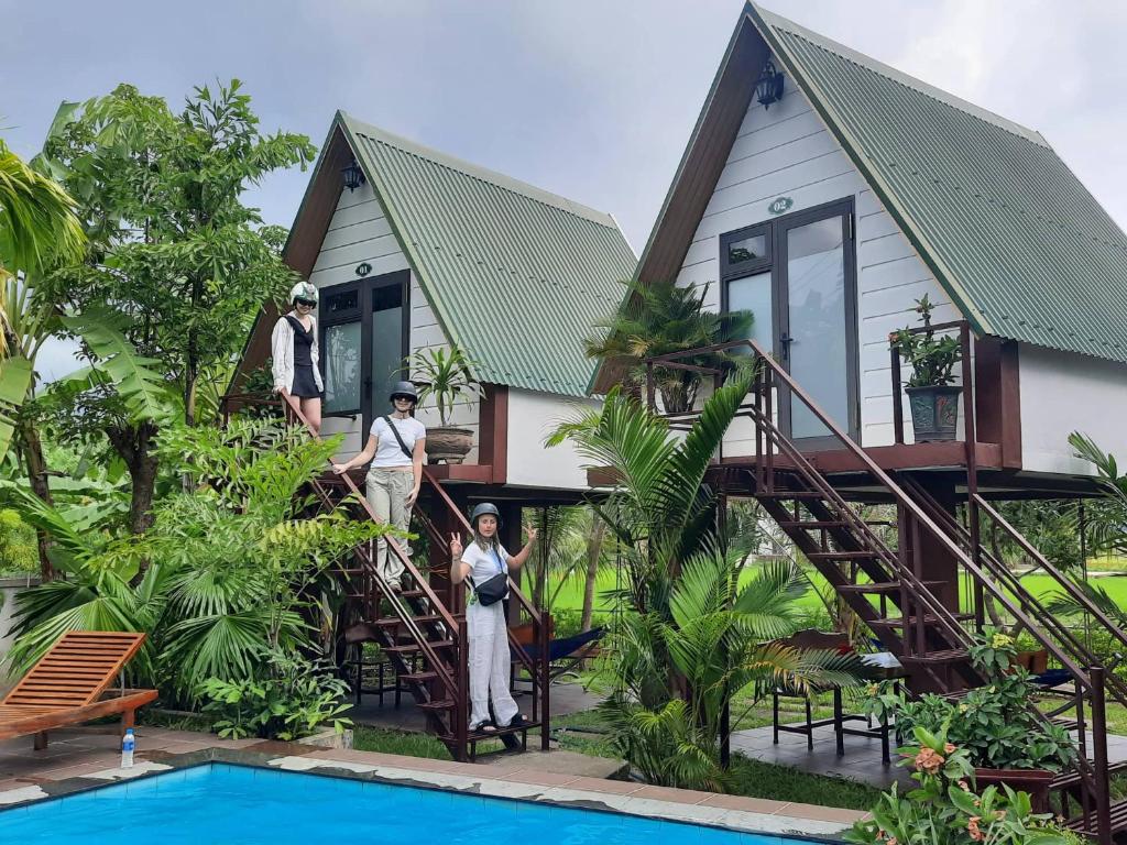 a group of people standing in front of a house at Hưng Phát Bungalow in Phong Nha