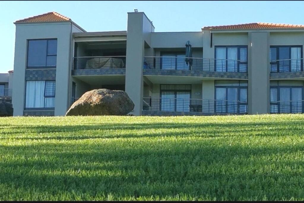 a large building with a large rock in front of it at NNS Vaal River Luxury 3 Bedrooms Apartment in Vanderbijlpark