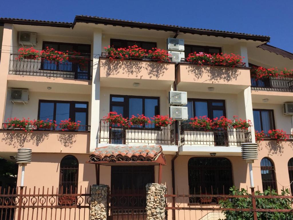 a building with flower boxes on the balconies at Guest House ,,Emotion'' in Balchik