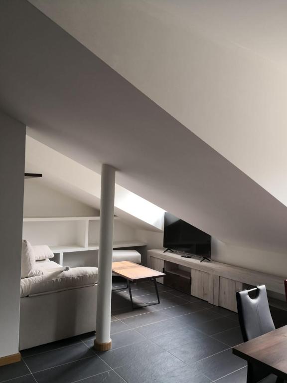 a room with a bed and a table and a couch at Aldea Bricia 20 BC in Posada de Llanes