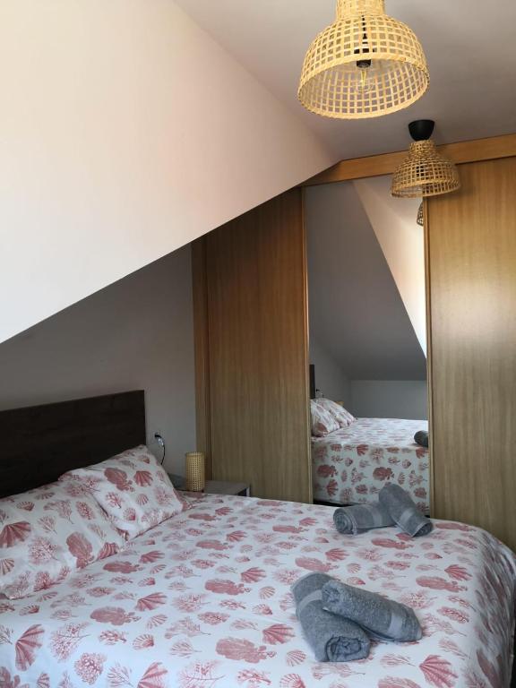 a bedroom with a bed and a large mirror at Aldea Bricia 20 BC in Posada de Llanes