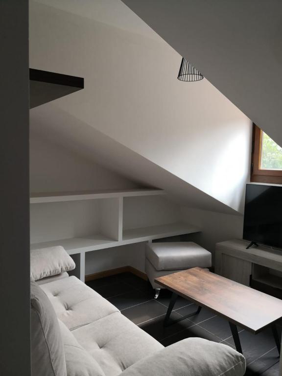 a living room with a couch and a table at Aldea Bricia 20 BC in Posada de Llanes