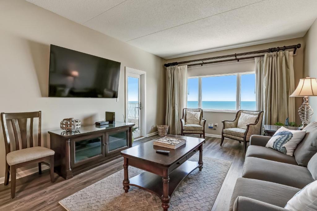 a living room with a couch and a table at Atlantic Ocean View Condo with Private Balcony and Access to Beachside Pool condo in Fernandina Beach