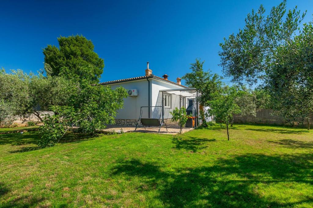 a small house in a garden with a yard at Chill out in Marčana