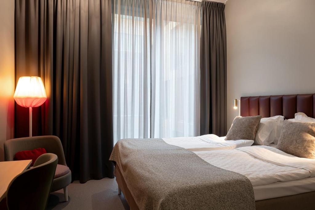 Postel nebo postele na pokoji v ubytování Elite Hotel Academia