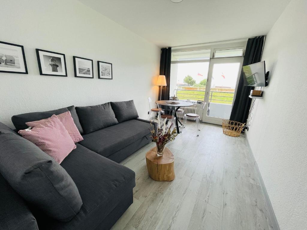 a living room with a couch and a table at Apartment Eerste Reeg für 2-4 Personen mit Pool in Dahme