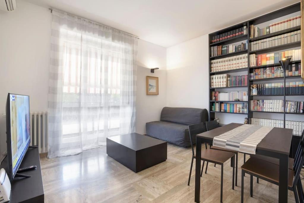 a living room with a couch and a table and a television at CASA KIKA Comoda, Luminosa e Accogliente in Milan