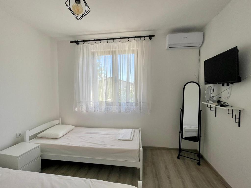 Postel nebo postele na pokoji v ubytování White apartments