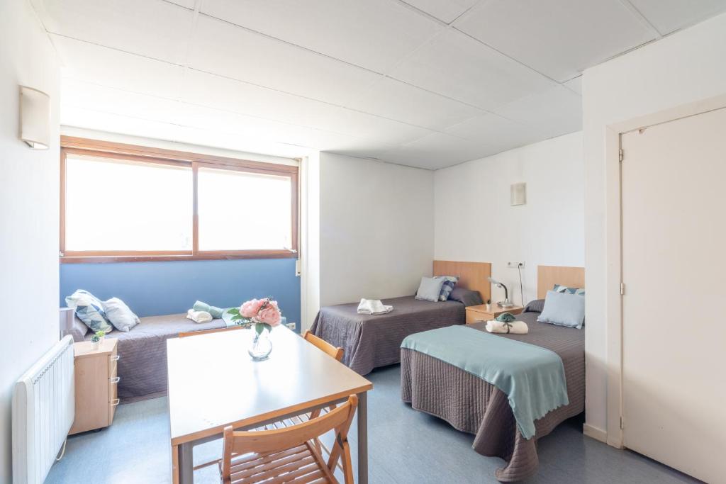 Postel nebo postele na pokoji v ubytování Residencia Universitaria Resa Lesseps