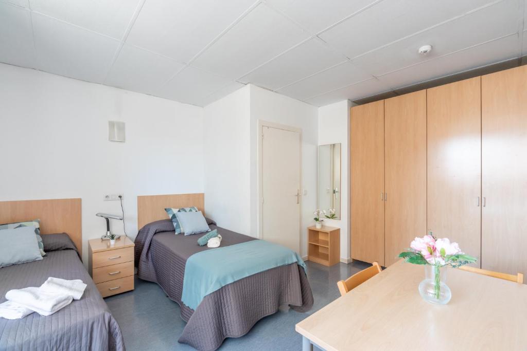 Postel nebo postele na pokoji v ubytování Residencia Universitaria Resa Lesseps