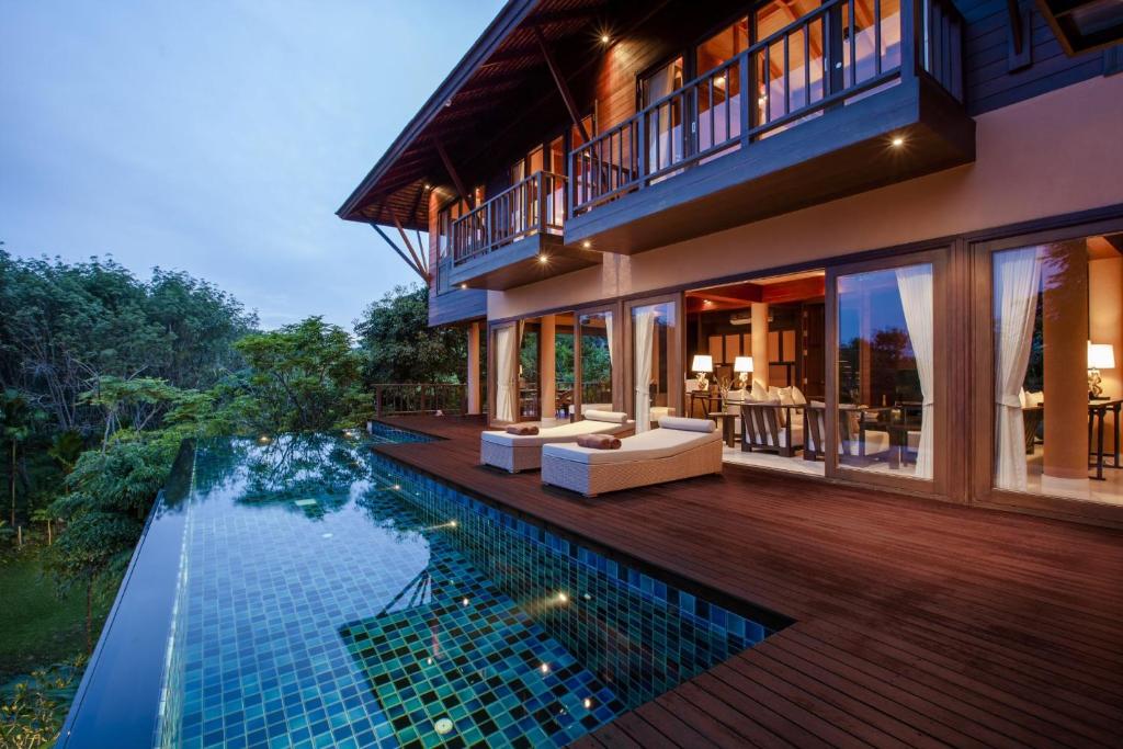 an exterior view of a house with a swimming pool at Villa Lydia, Koh Yao Noi in Ko Yao Noi