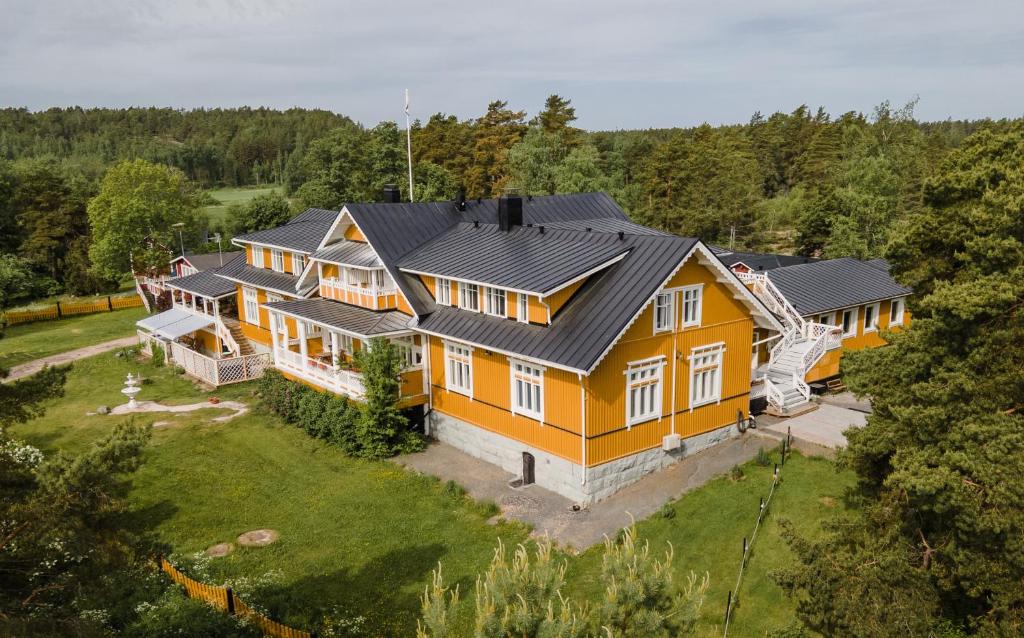 an aerial view of a large yellow house at Villa Ekbladh in Västanfjärd