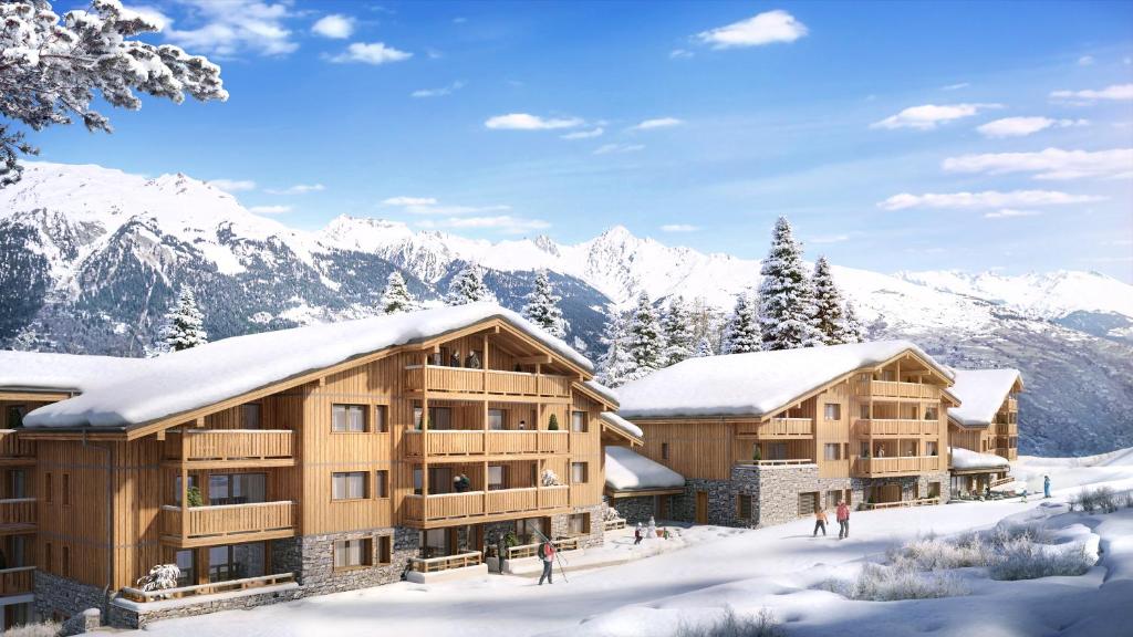 a ski lodge with snow covered mountains in the background at TERRESENS - Le Snoroc in Aime-La Plagne