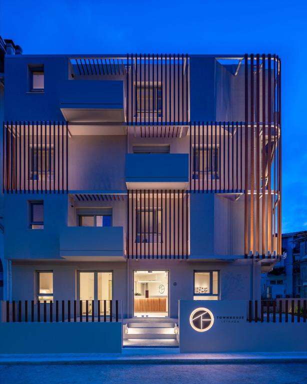 雷夫卡达镇Townhouse Lefkada的建筑的侧面有蓝色的灯光