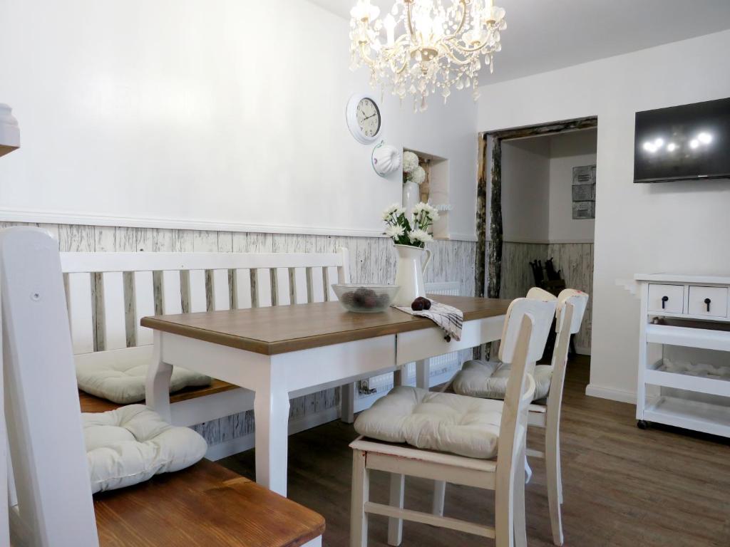 a dining room with a table and chairs and a chandelier at Gut Brüggen in Kerpen