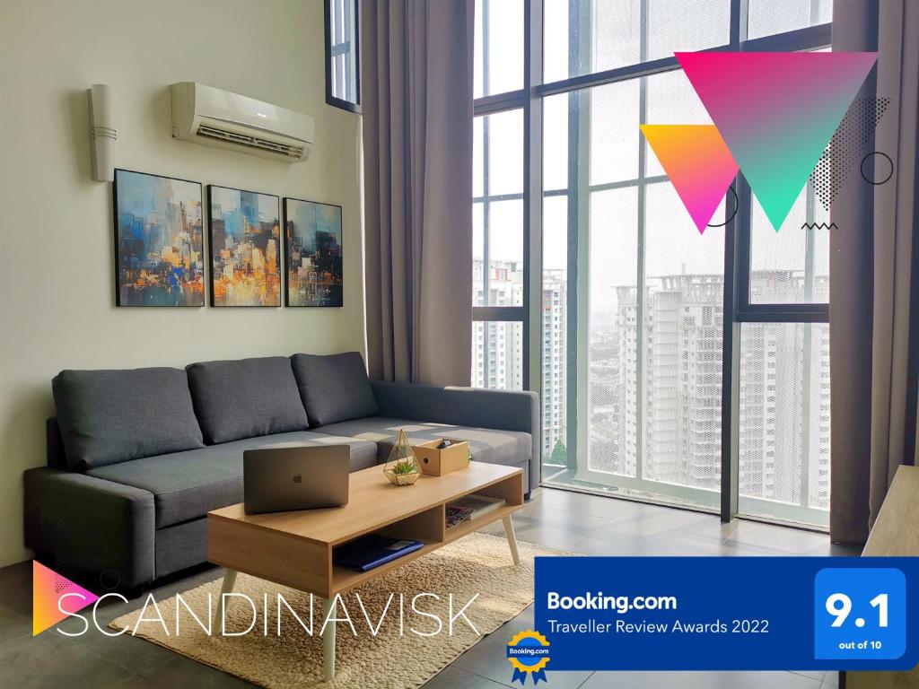 een woonkamer met een bank en een tafel bij 2Stories Empire Duplex at Damansara Perdana in Damansara Perdana