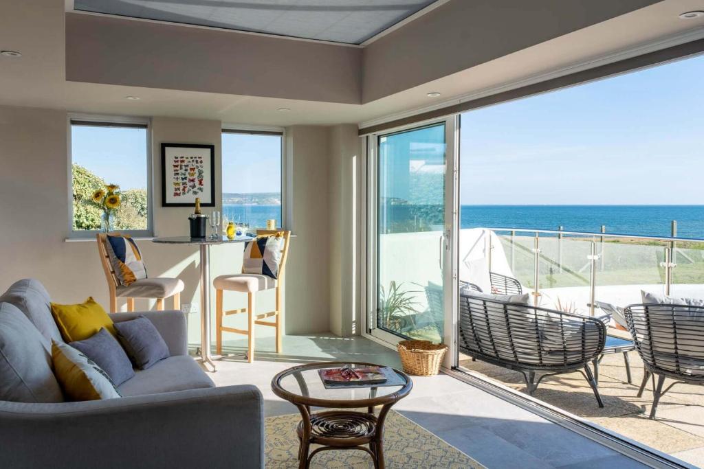 a living room with a view of the ocean at Needles Point in Milford on Sea