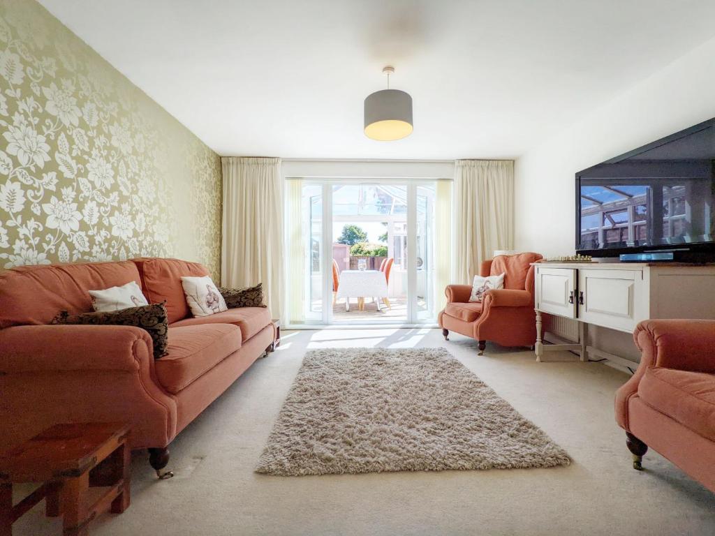 a living room with a couch and two chairs at East Shore Way - Portsmouth in Southsea