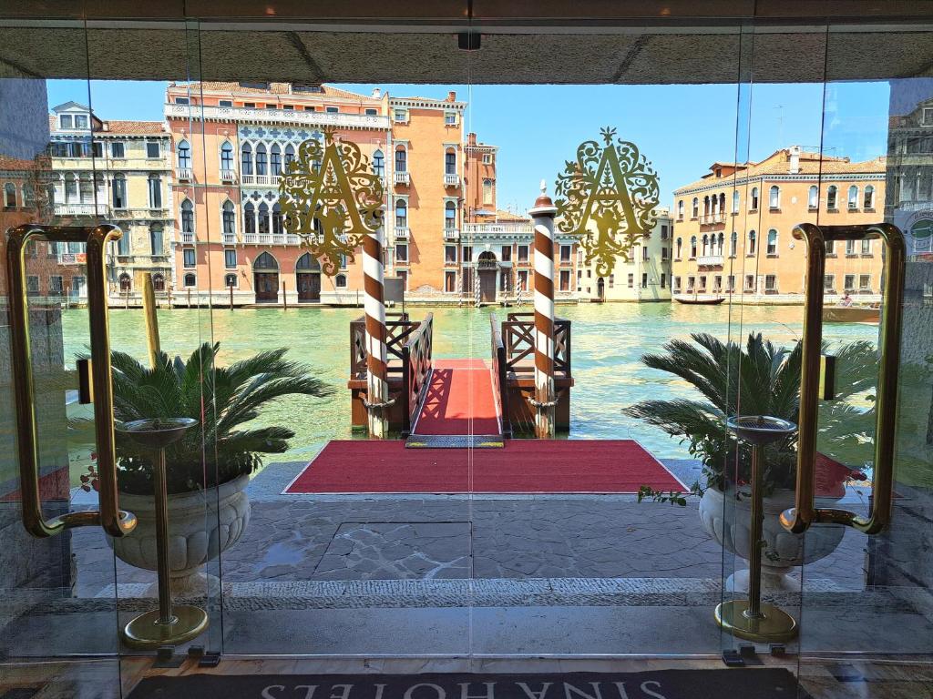 a window with a view of a river and buildings at Sina Palazzo Sant'Angelo in Venice