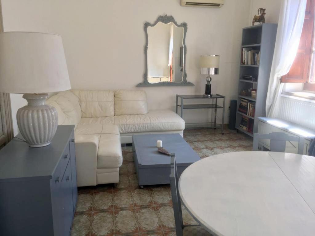 a living room with a white couch and a table at La villetta Blue in Palermo