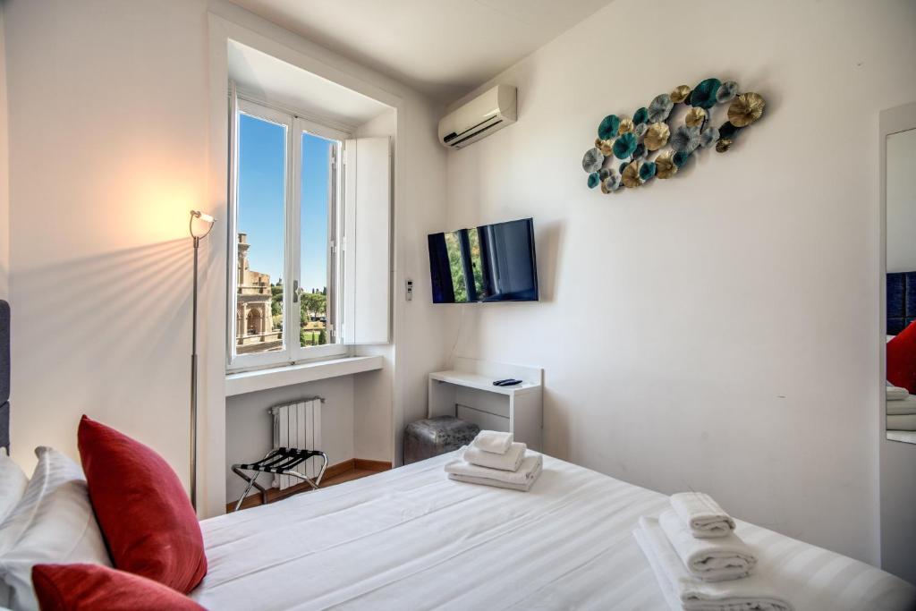 A bed or beds in a room at Magia at Colosseum