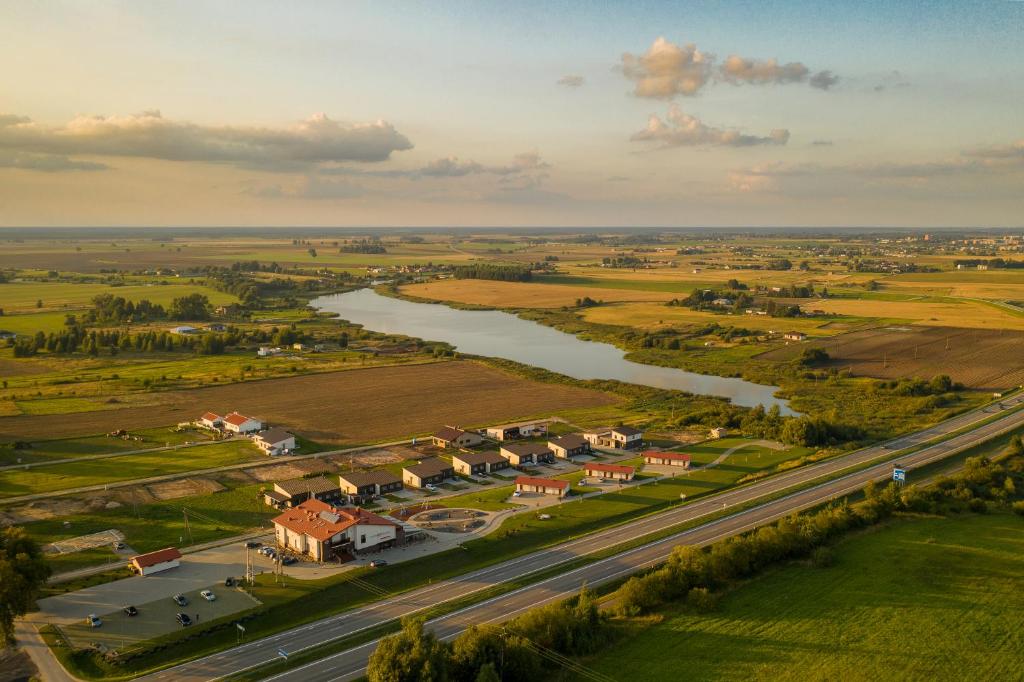 an aerial view of a town next to a river at Motel Panorama in Šiauliai