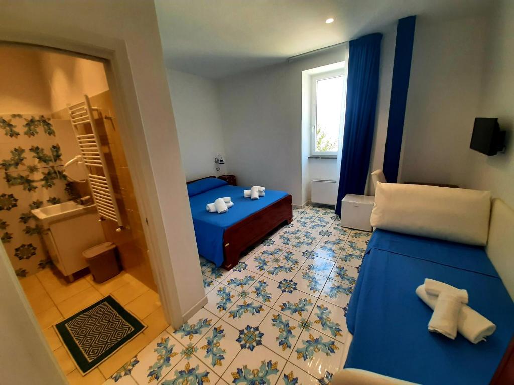 Кровать или кровати в номере O Guarracino Rooms