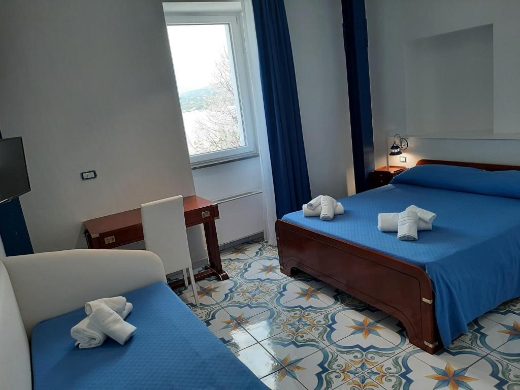 pokój hotelowy z dwoma łóżkami i oknem w obiekcie O Guarracino Rooms w mieście Palinuro