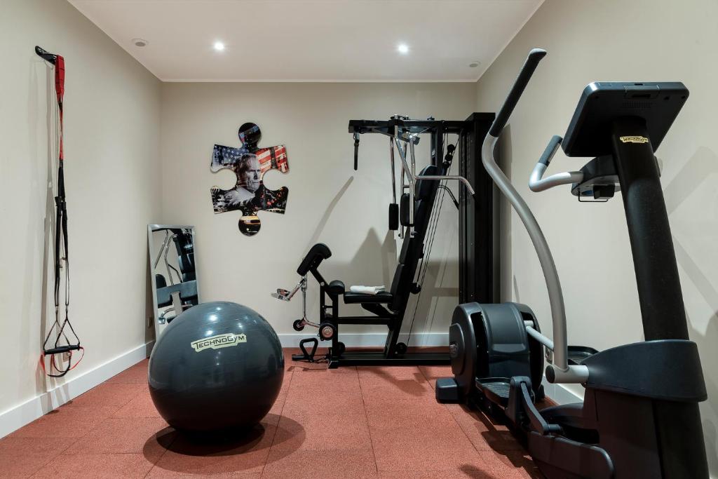 a room with a gym with a exercise ball and a treadmill at Grand Hôtel Dauphiné, Boutique Hôtel & Suites in Toulon