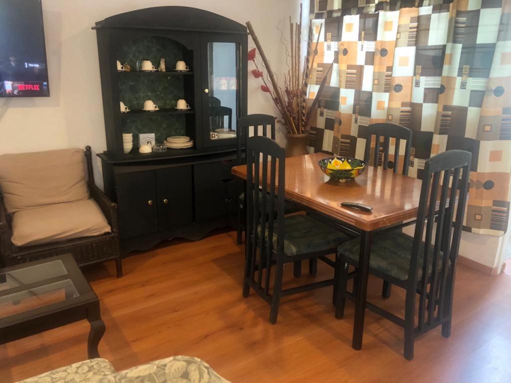 a dining room with a wooden table and chairs at Espacios de Pando in Puebla