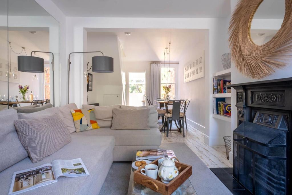 a living room with a couch and a fireplace at Nutshell Cottage in Lymington