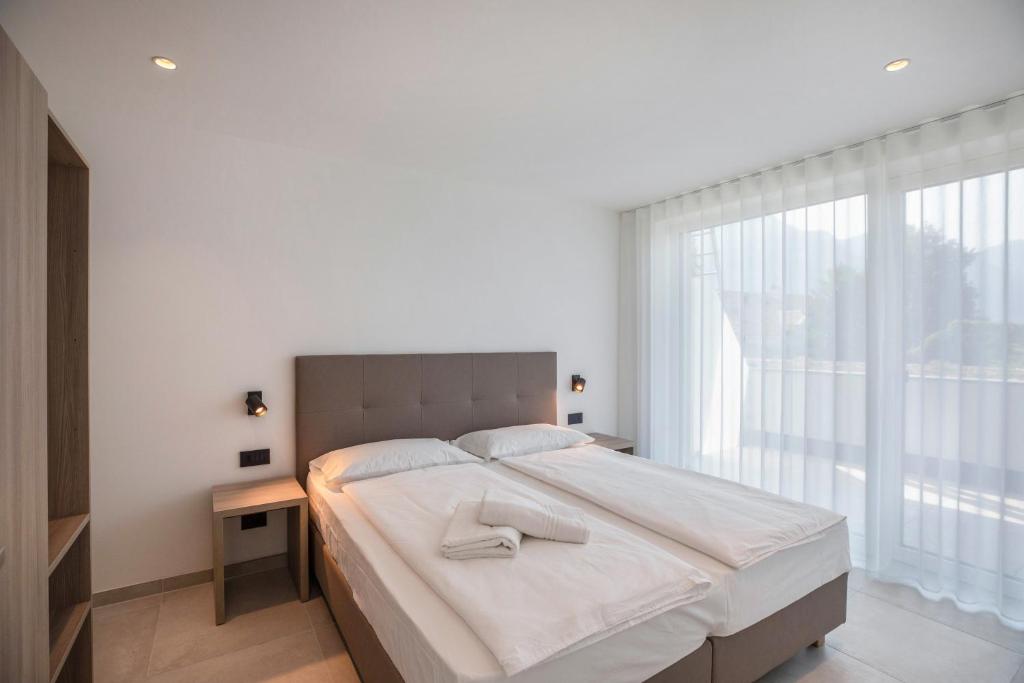 Postel nebo postele na pokoji v ubytování Apartments Curti - Himmelblau