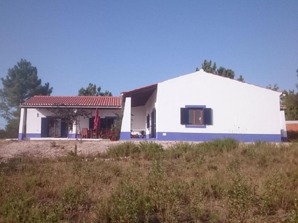 a white house with a red roof at Monte da Bela Vista - Luxury Villa 10 mins from best beaches in Portugal in Pedreneiras