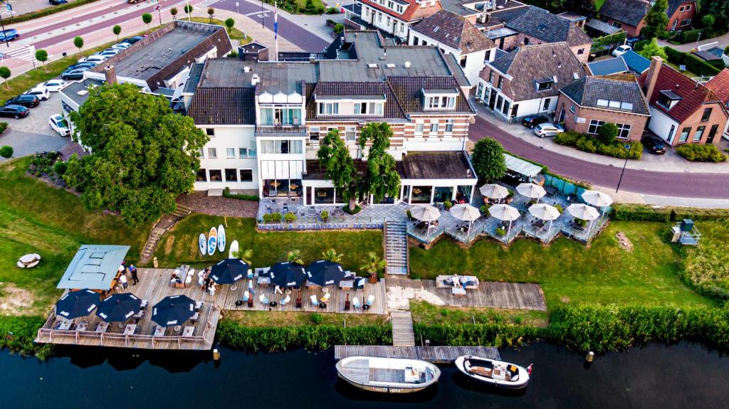 an aerial view of a house on the water at De Zon Hotel & Restaurant by Flow in Ommen