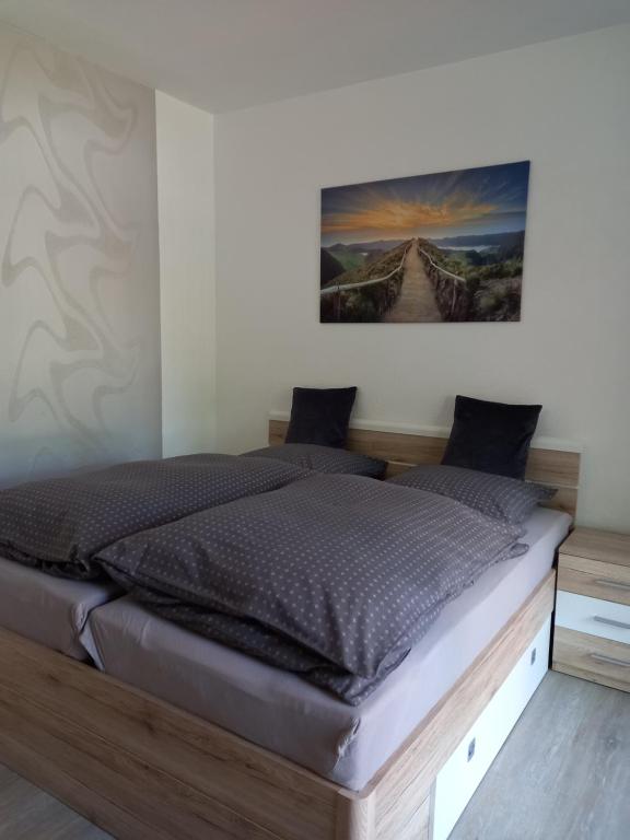 ein Bett in einem Schlafzimmer mit einem Bild an der Wand in der Unterkunft Appartment Hochpaterre in Springe