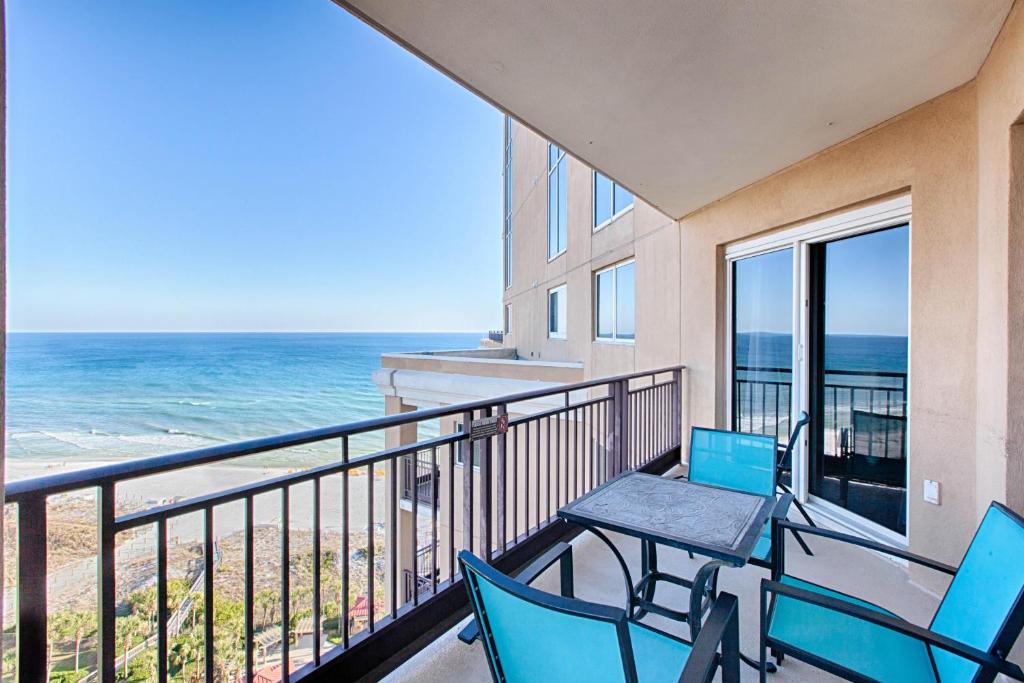 a balcony with a table and chairs and the ocean at Westwinds 4826 in Destin