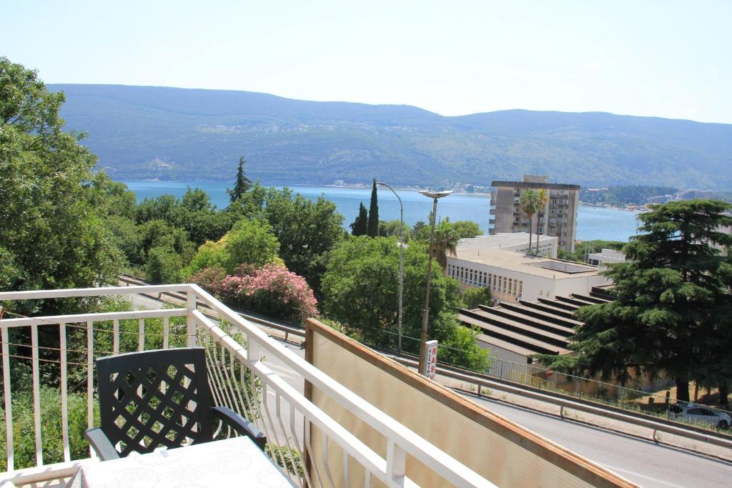 a balcony with a view of a city and a lake at Apartments Mediteran in Herceg-Novi