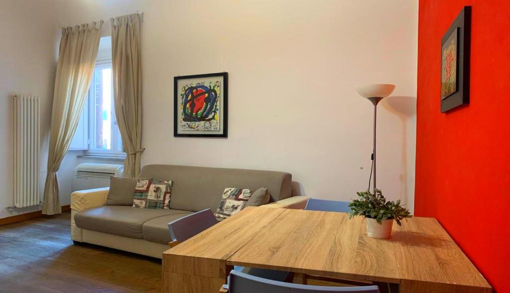 a living room with a table and a couch at Sforza Apartment in Rome