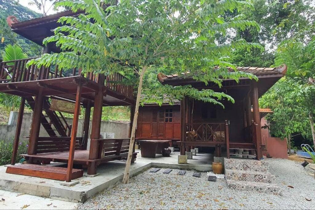 a small house with a tree in front of it at THE DENAI Langkawi in Kuah