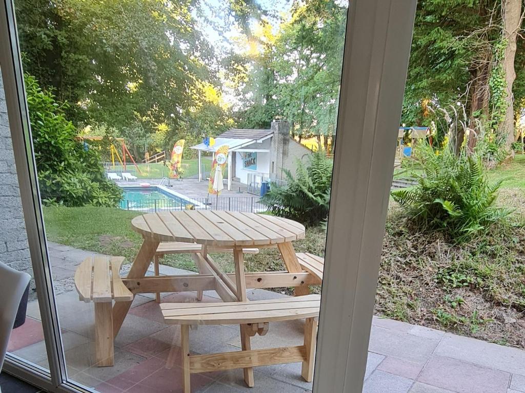 a picnic table and bench on a patio at 3 Manor Villas Newquay in Newquay